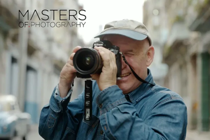 Steve McCurry photographing with a camera during his photography course